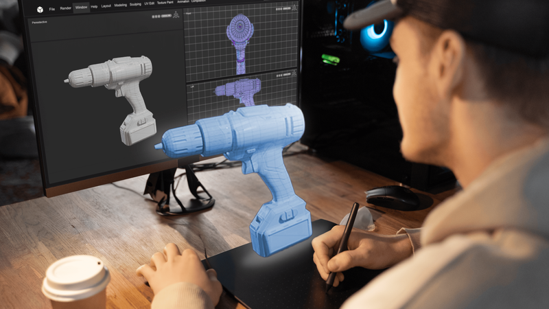 Man working on a 3D model of an electric screwdriver behind a computer screen with 2D blueprints of the screwdriver.